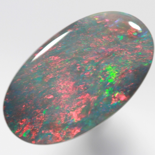 SOLID BLACK OPAL Bright red rolling flashes over green and blue sparkles SEE VIDEO